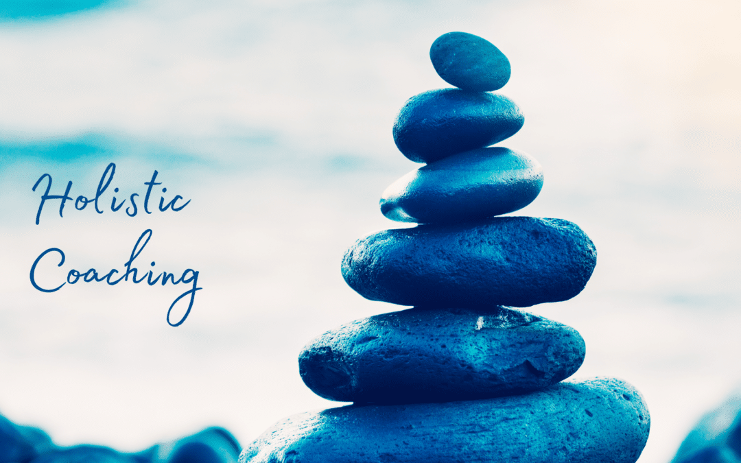 Relaxing photo with blue pebbles writing Holistic Coaching